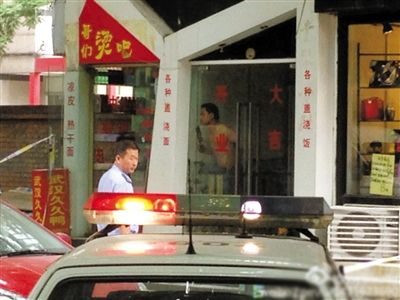 闖入面館的持刀男子與趕來的民警隔著玻璃門對(duì)峙，后店內(nèi)一名女童被其劫持。網(wǎng)友供圖