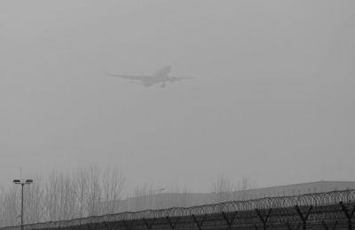 在首都機場，飛機在霧霾中降落。