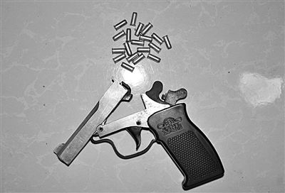 警方從搶劫嫌疑人處起獲的贓款和發(fā)令槍、子彈。警方供圖