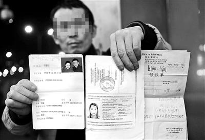 賀先生向記者出示他與越南妻子的結(jié)婚證、新娘護(hù)照和部分相關(guān)交費(fèi)單據(jù) 攝影/本報(bào)記者　袁藝