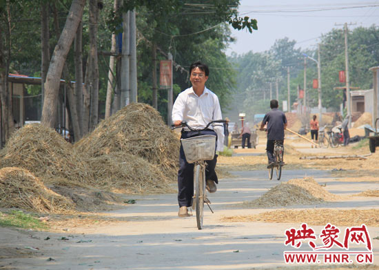圖為王格現(xiàn)騎著自行車去學(xué)校。