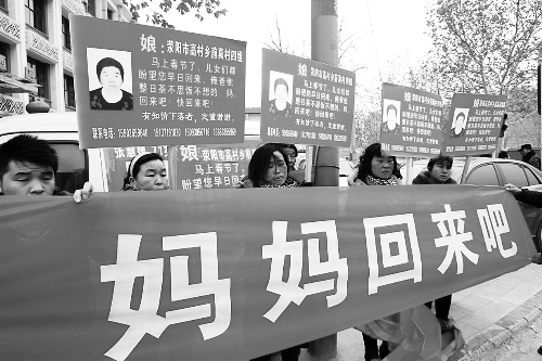 張慧媛老人的子女們舉著尋找母親的牌子和橫幅，在冷風中呼喊著“媽媽，您快回來吧”。