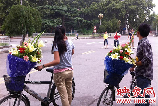 在鄭州大學(xué)南校區(qū)，有不少學(xué)生三五成群，手捧鮮花。