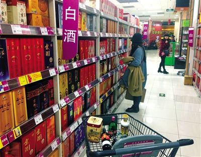 顧客在商場的高檔白酒貨架前駐足挑選。春節(jié)臨近，受“禁令”影響，以高檔白酒為代表的節(jié)日禮品市場面臨考驗。記者 王遠征 攝