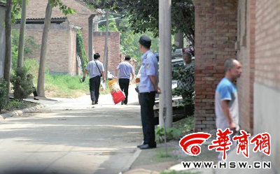 昨日,西安市閻良區(qū)譚家村,警方在事發(fā)的孫某家里勘查現場后,將提取的物證帶走 華商報記者 黃利健 攝