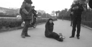 鄭大姐坐在地上，警方趕到進(jìn)行施救。（視頻截圖由警方提供）